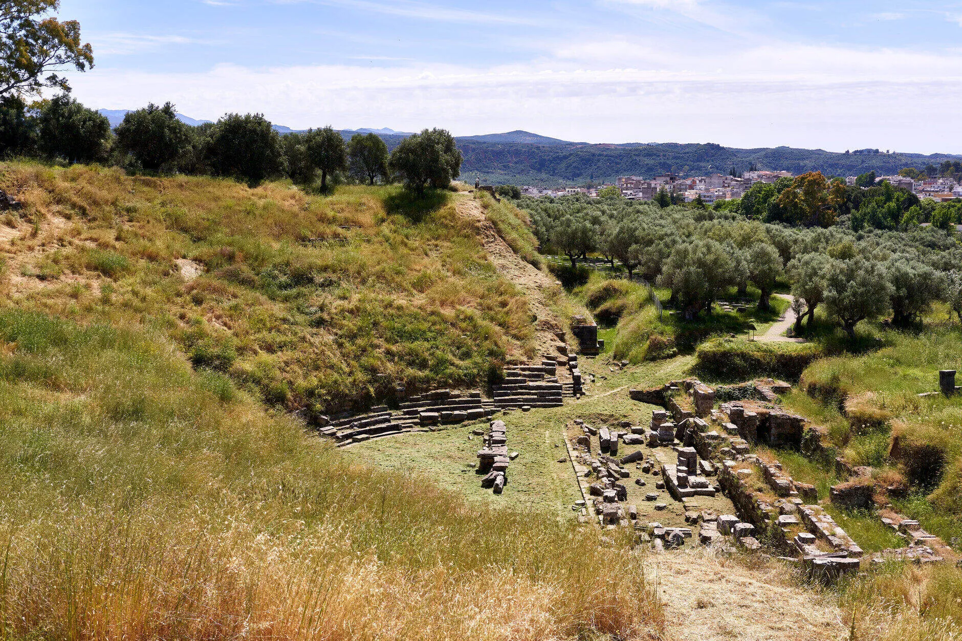 The ruins of the ancient theatre of Sparta on the southern slope of the acropolis hill, 15 May 2019. Photo: George E. Koronaios. Licence: CC0 1.0 (public domain dedication). Source: Wikimedia Commons